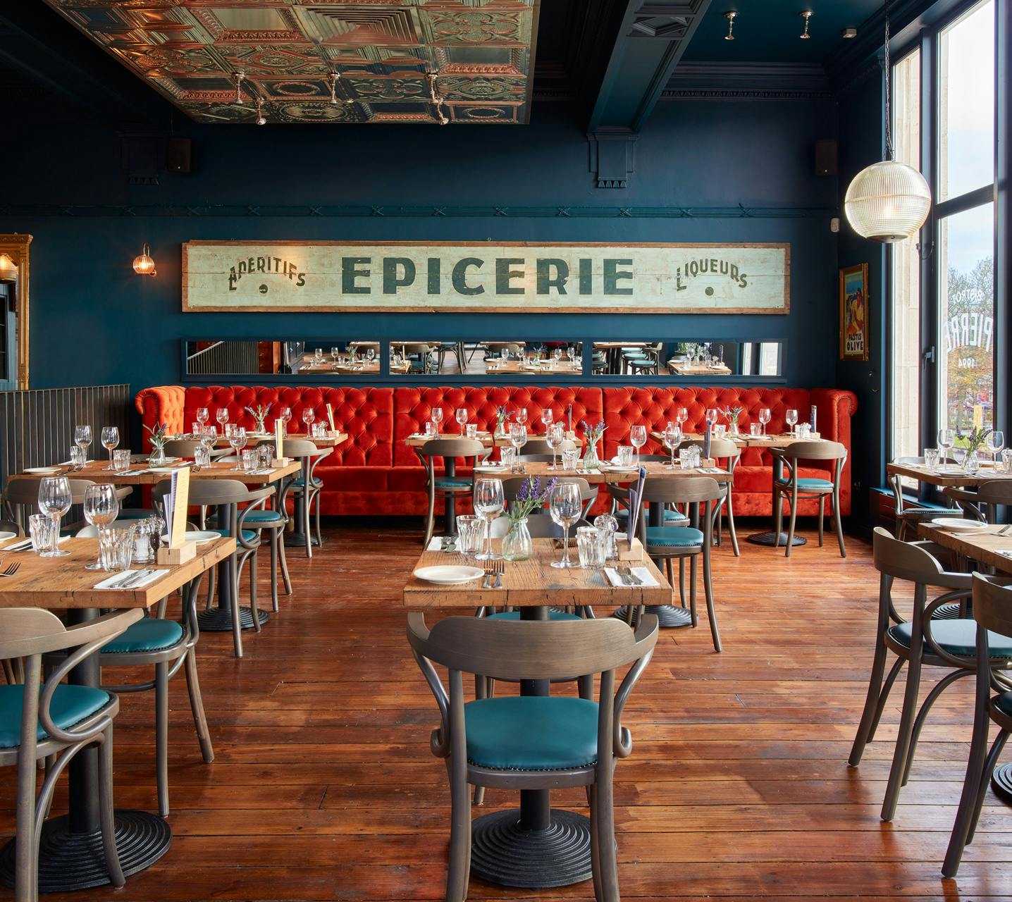 Stylish restaurant interior with red banquette, ideal for corporate events and gatherings.