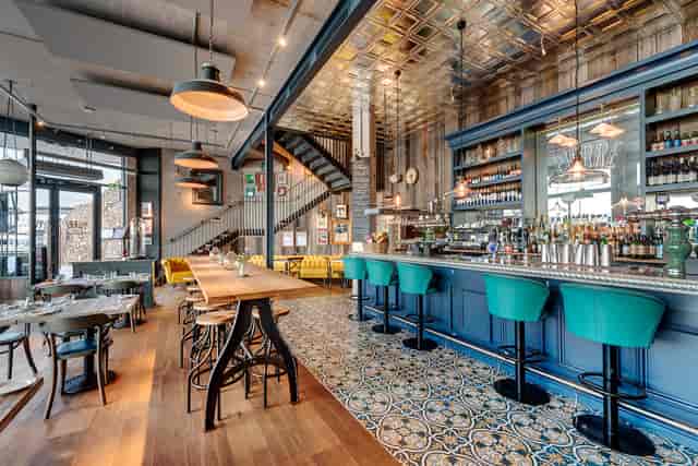 Stylish Bar Pierre with teal stools, ideal for networking events in Torquay.