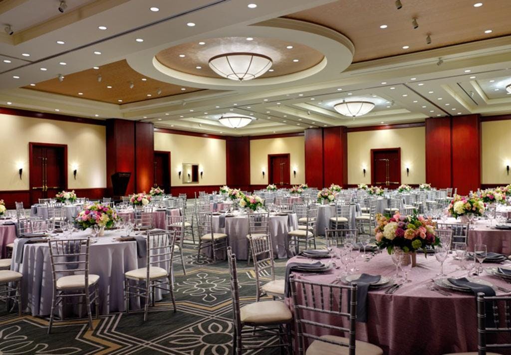 Elegant banquet hall with floral centerpieces, perfect for weddings and corporate events.