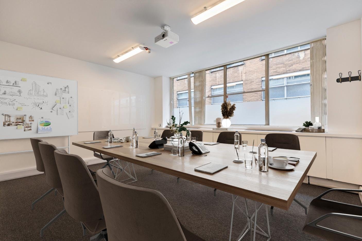 Modern meeting room with large wooden table, ideal for collaborative sessions.