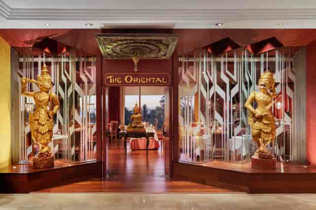 Elegant hotel lobby with ornate statues, ideal for upscale dining events and gatherings.