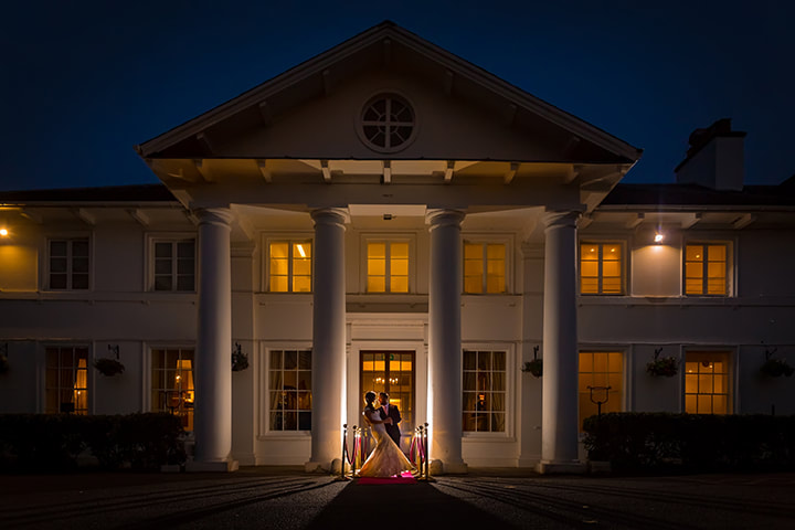 Elegant Dyrham Park Country Club bridge at night, perfect for weddings and upscale events. - Banner