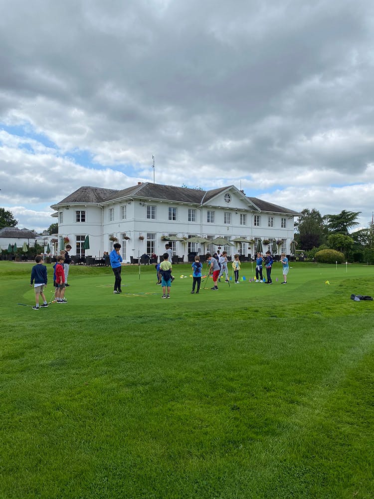 Children at a golf clinic in Dyrham Park Country Club, ideal for corporate events.