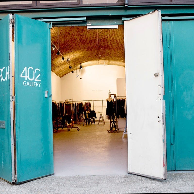 Main Gallery Room at Hoxton Arches, industrial-chic event space with turquoise doors.