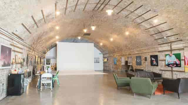 Glass House event space with arched ceiling, ideal for workshops and exhibitions.