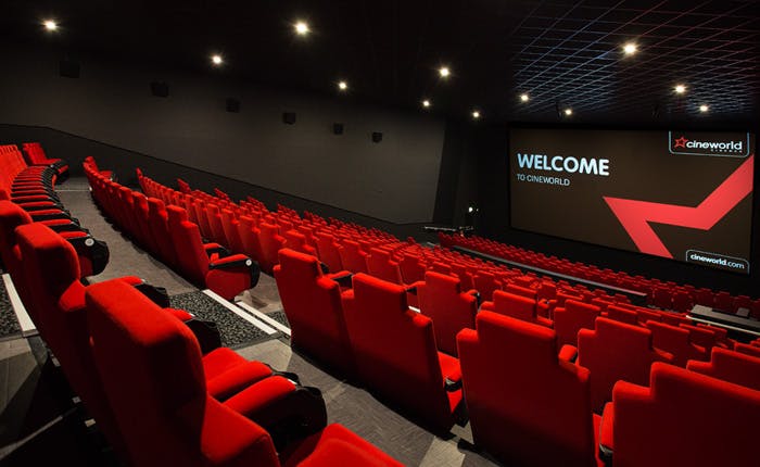 Modern cinema auditorium with red seating, perfect for corporate events and film screenings.