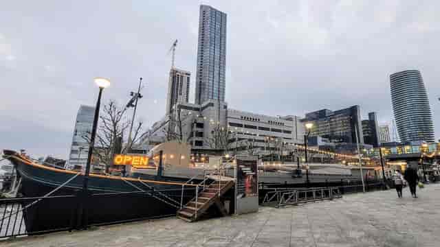 Vibrant waterfront event space with modern skyline, ideal for networking and gatherings.