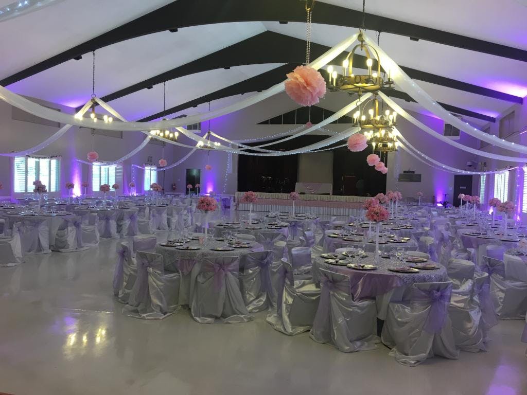 Elegant Friendship Auditorium event space with silver linens, ideal for weddings and gatherings.