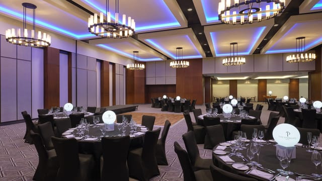 Elegant event space with black linens, perfect for corporate dinners and weddings.