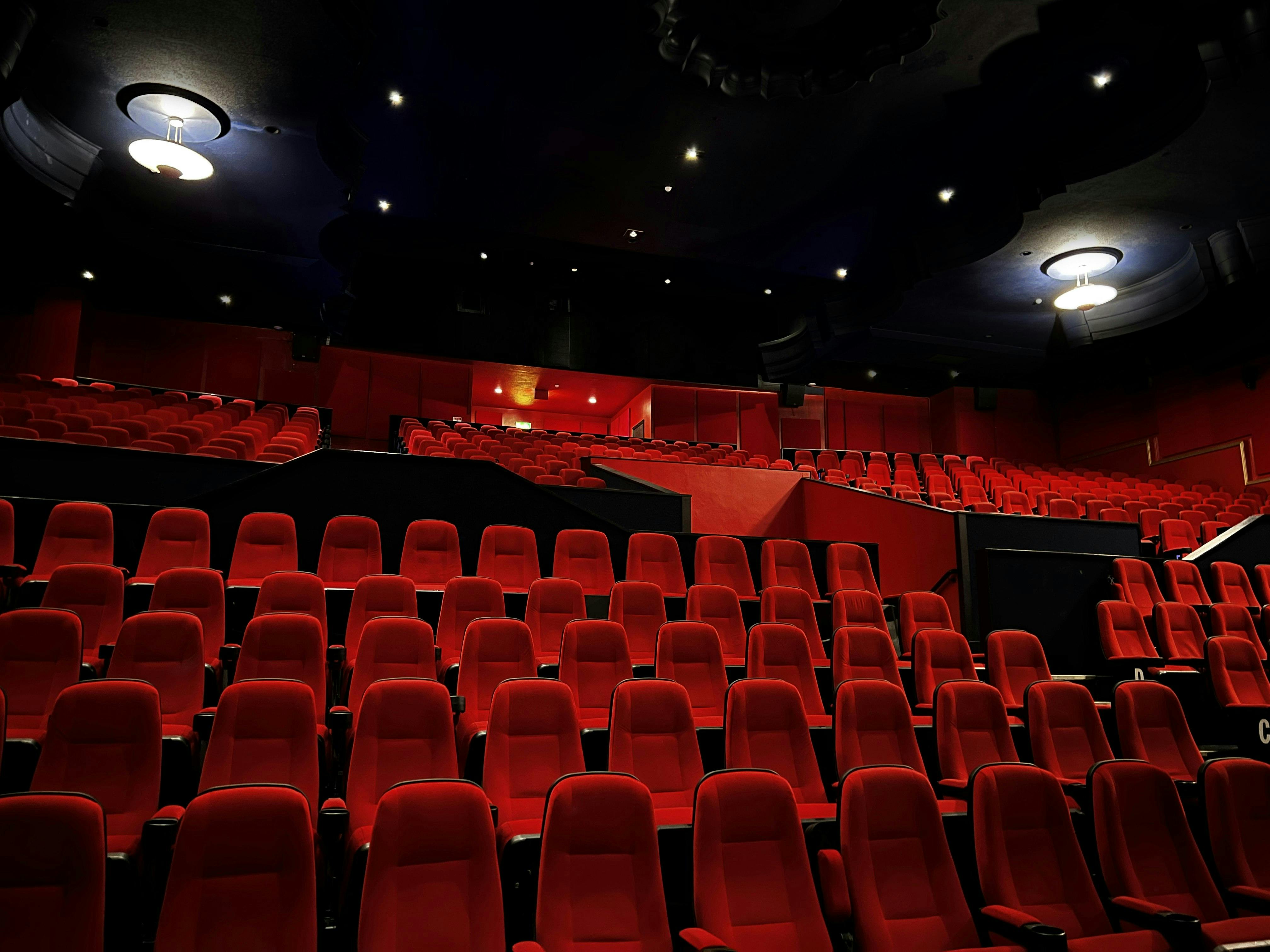 Spacious Genesis Cinema theater with plush red seating for corporate events and film screenings.