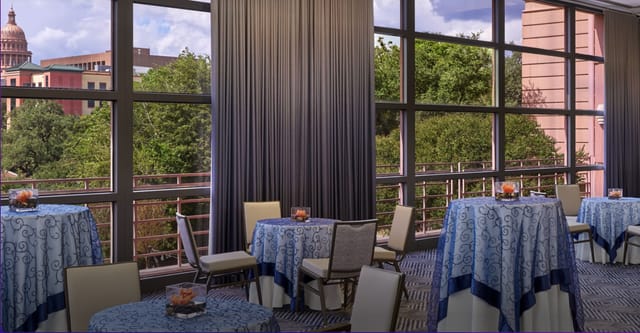 Elegant Capitol Ballroom E with blue tablecloths, perfect for networking events and receptions.
