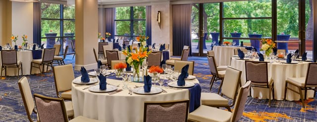 Elegant Capitol Ballroom E with round tables, ideal for meetings and banquets in Austin.