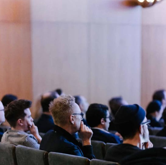 Engaged audience at Sparks theater conference, showcasing dynamic speakers and immersive experience.