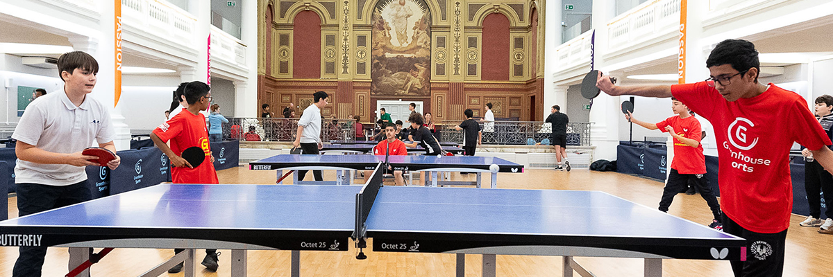 Table tennis event at The Harrow Club with vibrant participants and elegant decor. - Banner