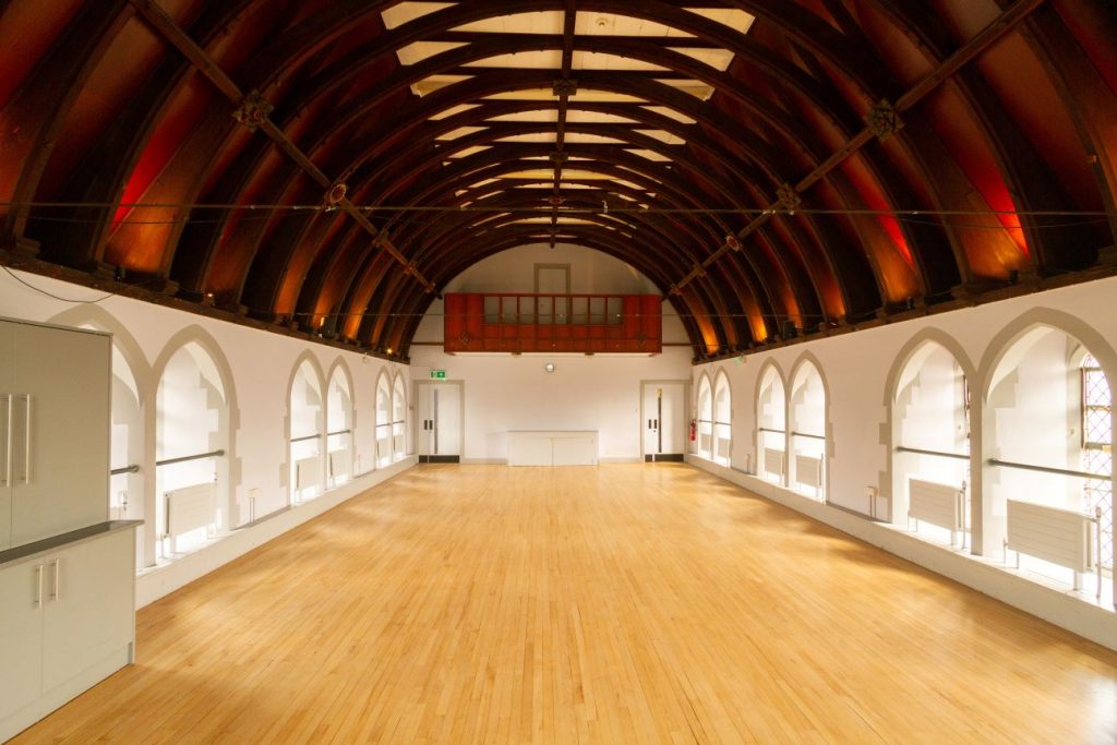 Mortlake Village Hall with arched ceiling, ideal for corporate and social events. - Banner