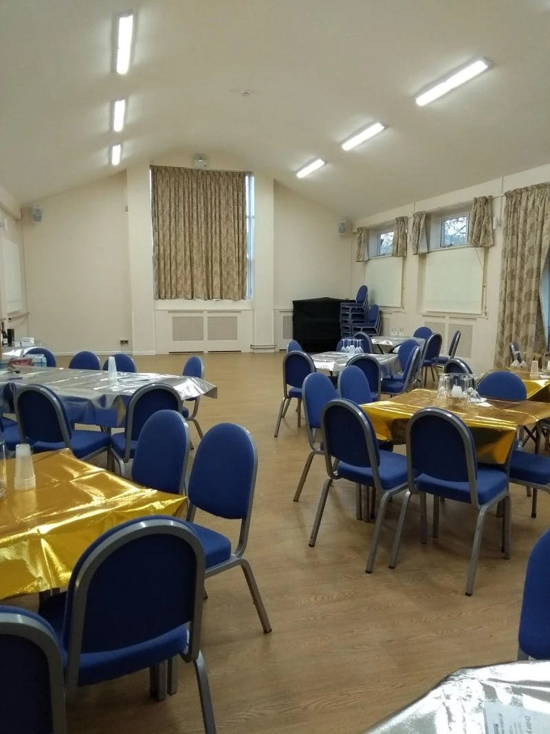 Versatile Mortlake Hall event space with blue chairs, ideal for gatherings and meetings.