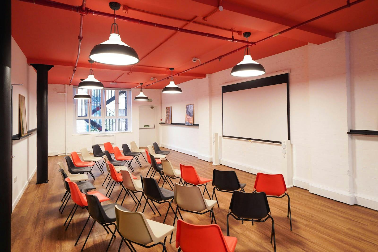 Versatile London Bridge Hive workshop space with colorful chairs for engaging meetings. - Banner