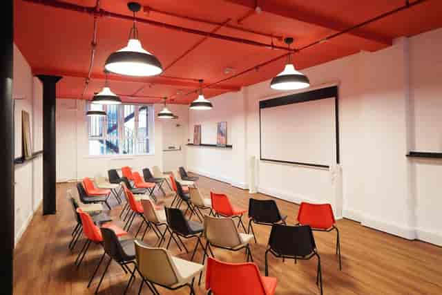 Versatile London Bridge Hive workshop space with colorful chairs for engaging meetings.