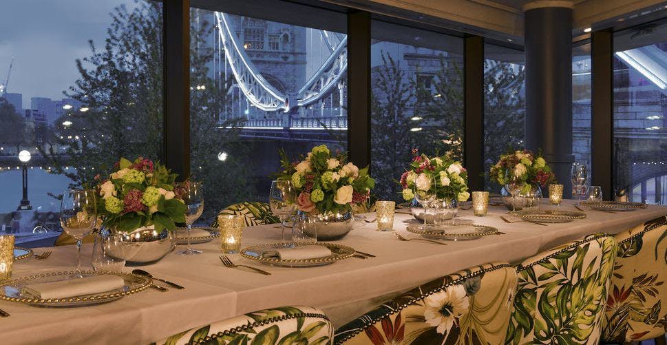 Elegant dining table with floral centerpieces at The View Room, Ivy Tower Bridge, for upscale events.