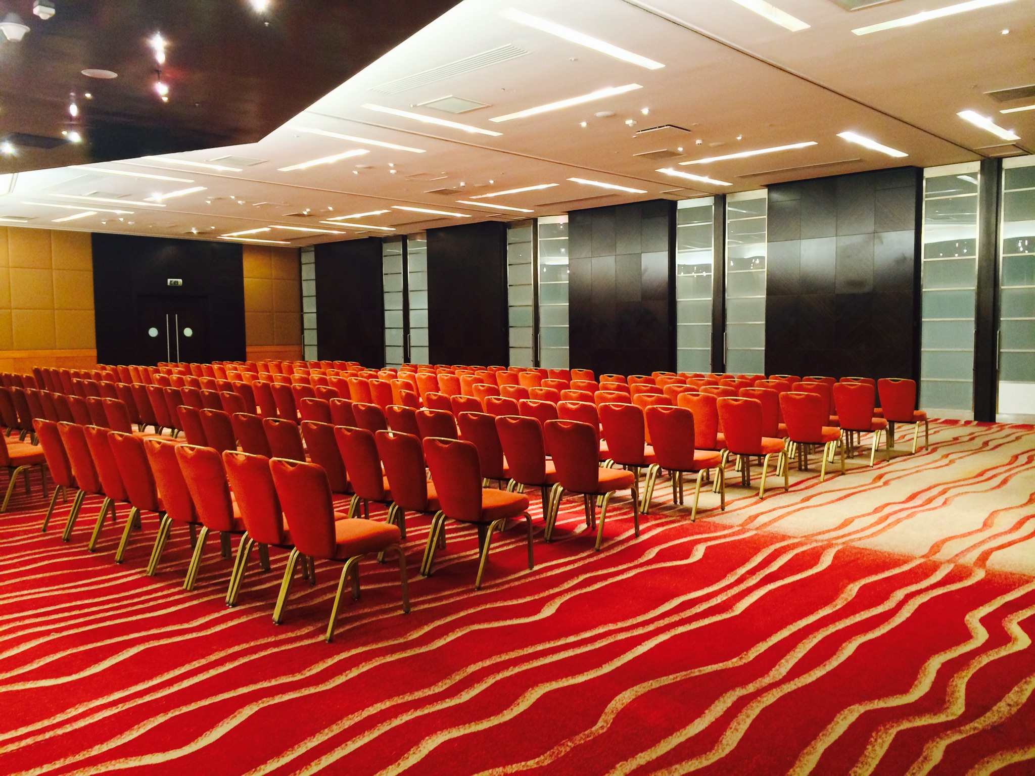 London Riverbank conference ballroom, orange seats, tech event - Banner