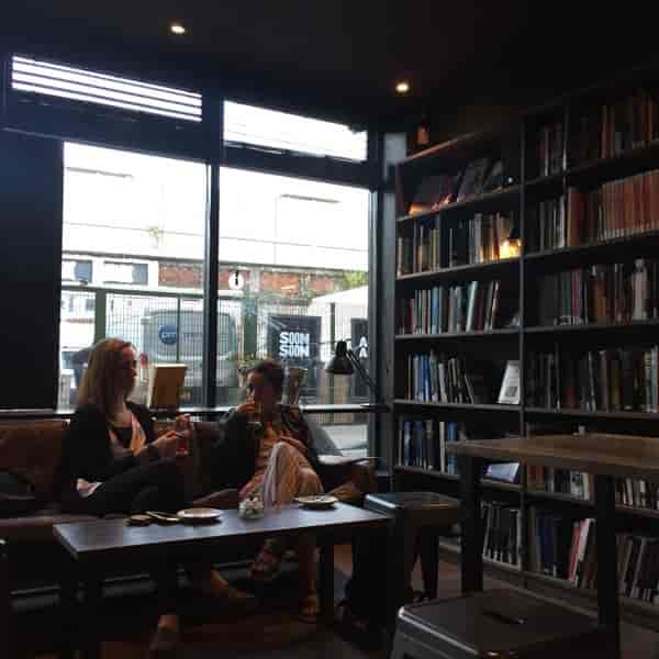 Cozy cafe with warm lighting, ideal for networking and brainstorming events.