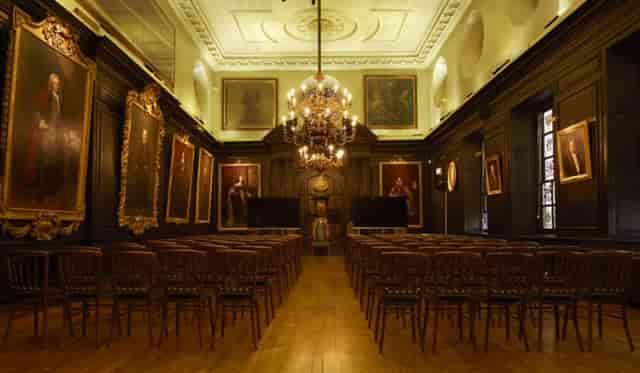 Elegant meeting room with wooden paneling, perfect for formal events and presentations.