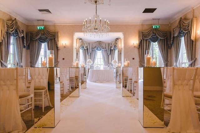 Elegant wedding venue with mirrored decor and soft lighting at De Courceys Manor.