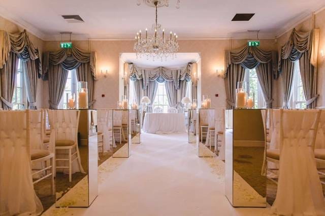 Elegant wedding venue with mirrored decor and soft lighting at De Courceys Manor.