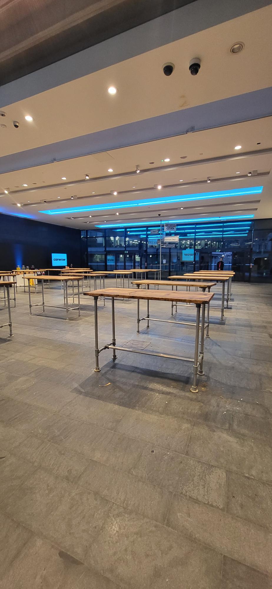 Spacious London Museum Entrance Hall with high-top tables for networking events.