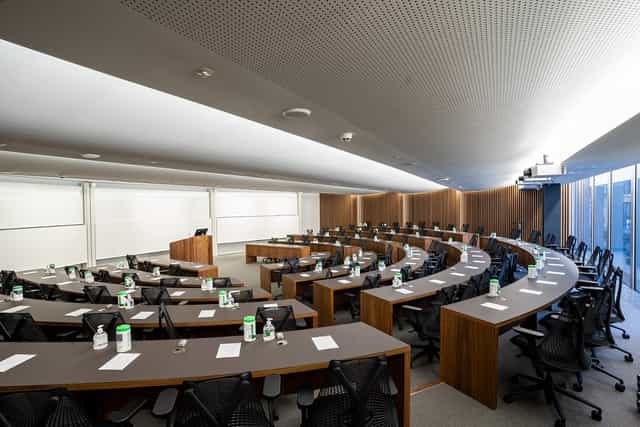 Modern MBA classroom in London with tiered seating for workshops and seminars.
