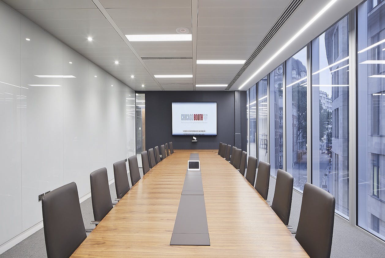 Modern London conference room with wooden table, ideal for meetings and presentations.