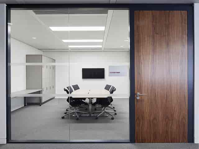 Modern meeting room with glass walls for professional conferences and business workshops.