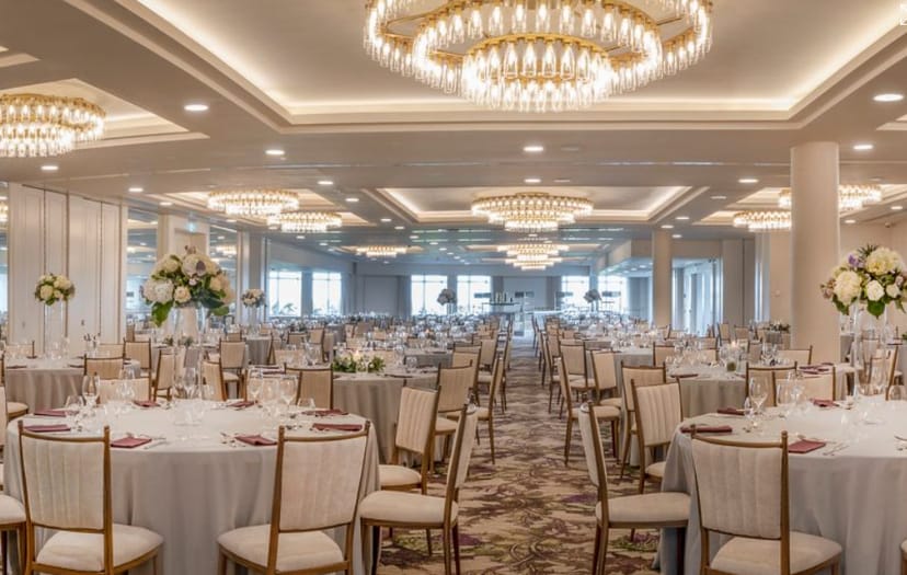 Elegant event space with round tables, ideal for weddings and corporate events.