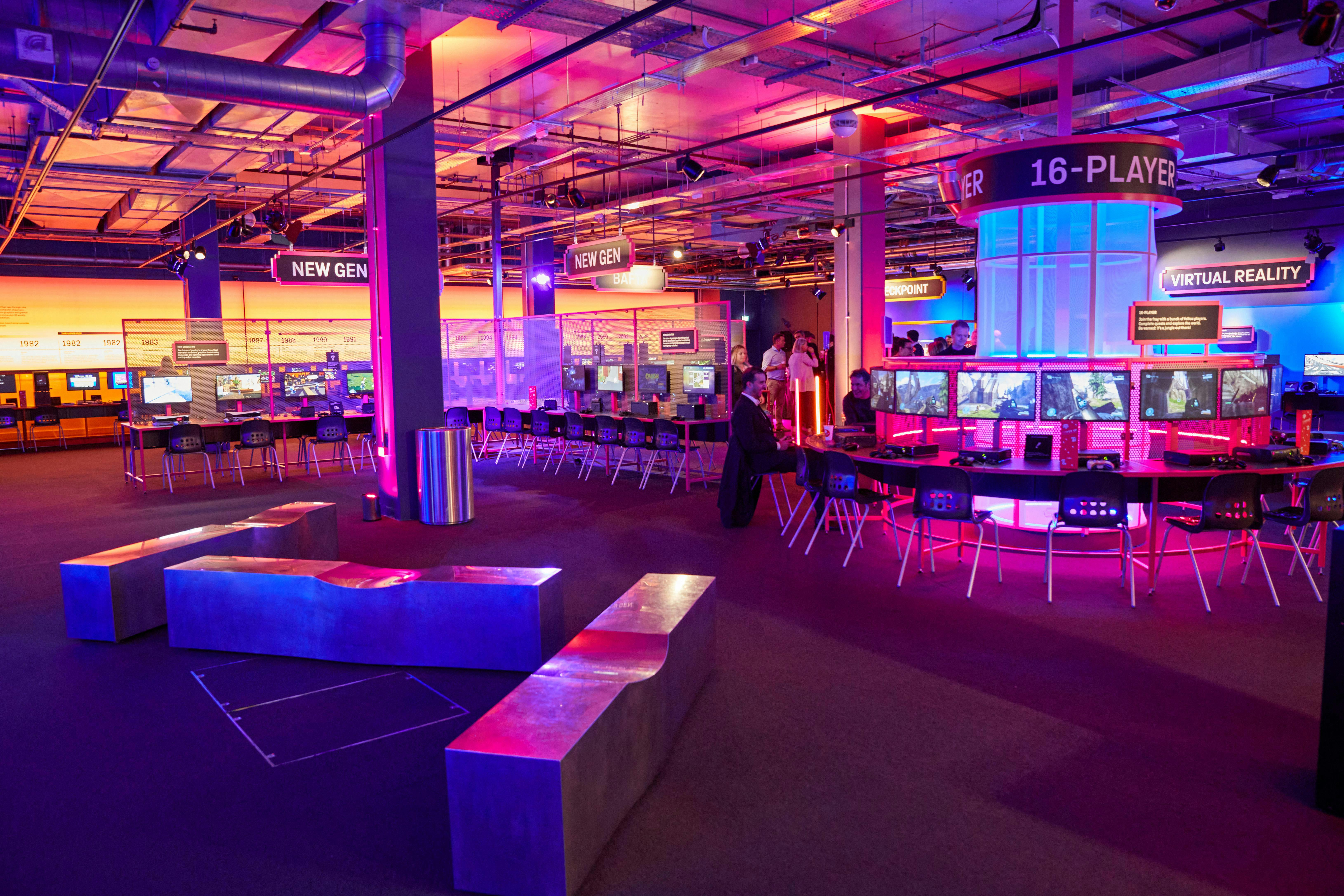 Vibrant gaming event space at The Science Museum with colorful lighting and interactive stations.