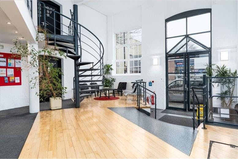Modern meeting room lobby with spiral staircase, ideal for events and gatherings.