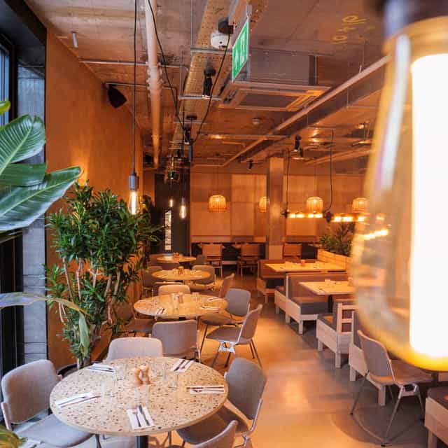 Modern restaurant space with warm lighting for corporate events and intimate gatherings.