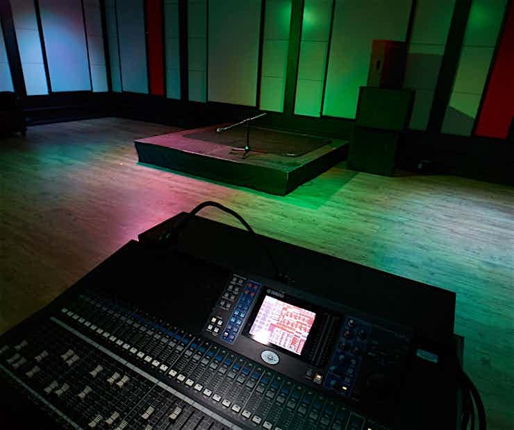 Versatile event space with sound console, perfect for live performances and meetings.