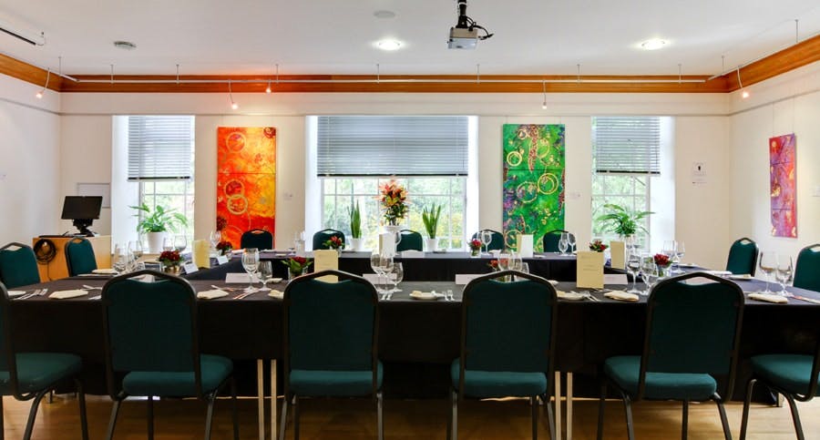 Classroom Hire in Knapp Gallery: organized meeting room with vibrant artwork for events.