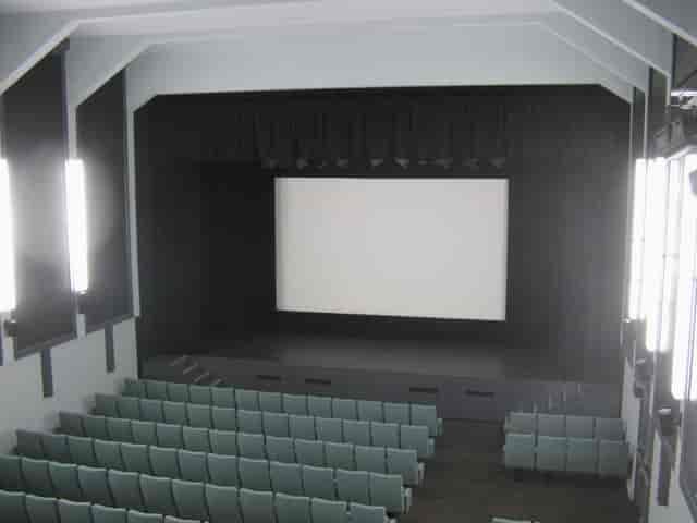 Ciné Lumière auditorium with tiered seating for conferences and film screenings.