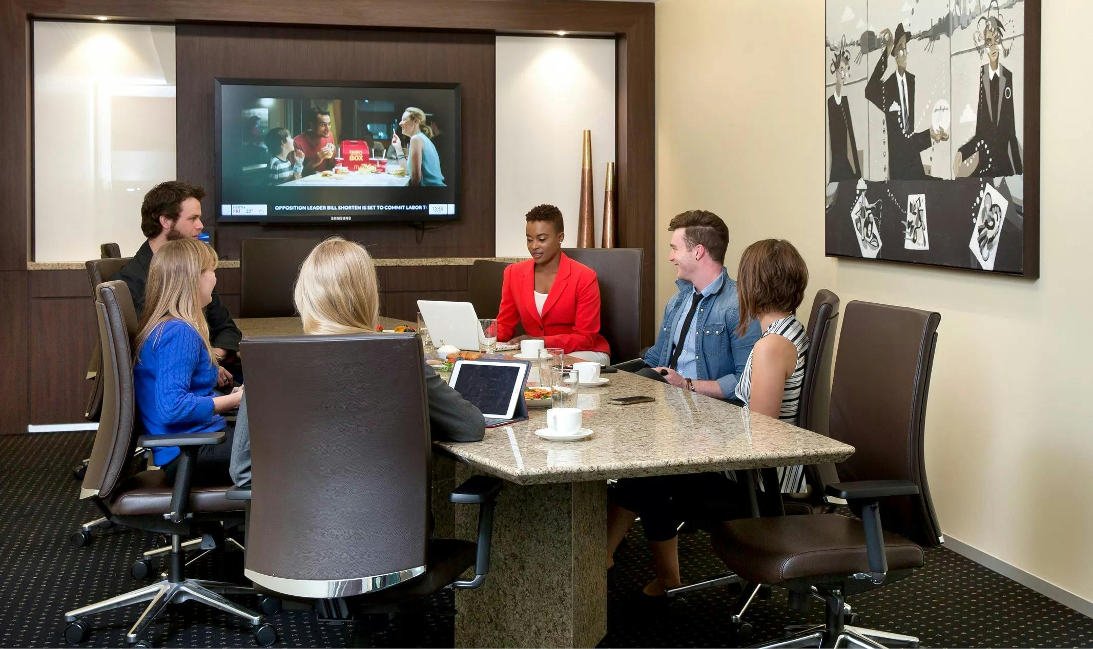 Modern meeting room at Servcorp Canary Wharf with professionals collaborating.