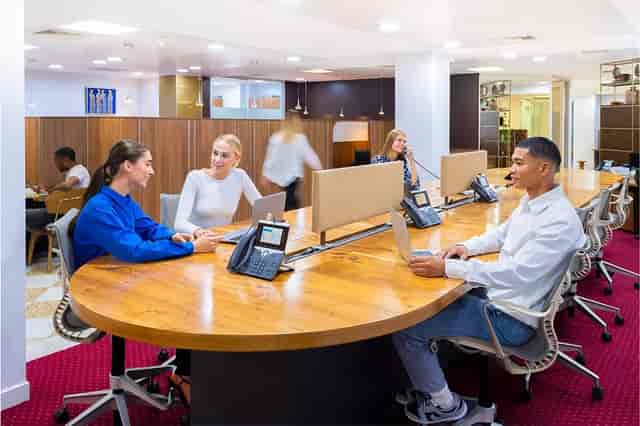 Modern co-working meeting room with round table for collaboration at Servcorp Canary Wharf.