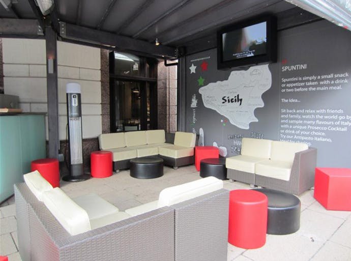 Stylish outdoor lounge terrace with vibrant tables for casual networking events.