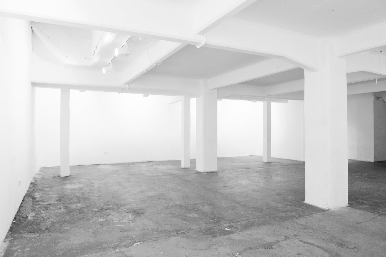 Spacious Hoxton Basement venue with white walls for customizable events and workshops.