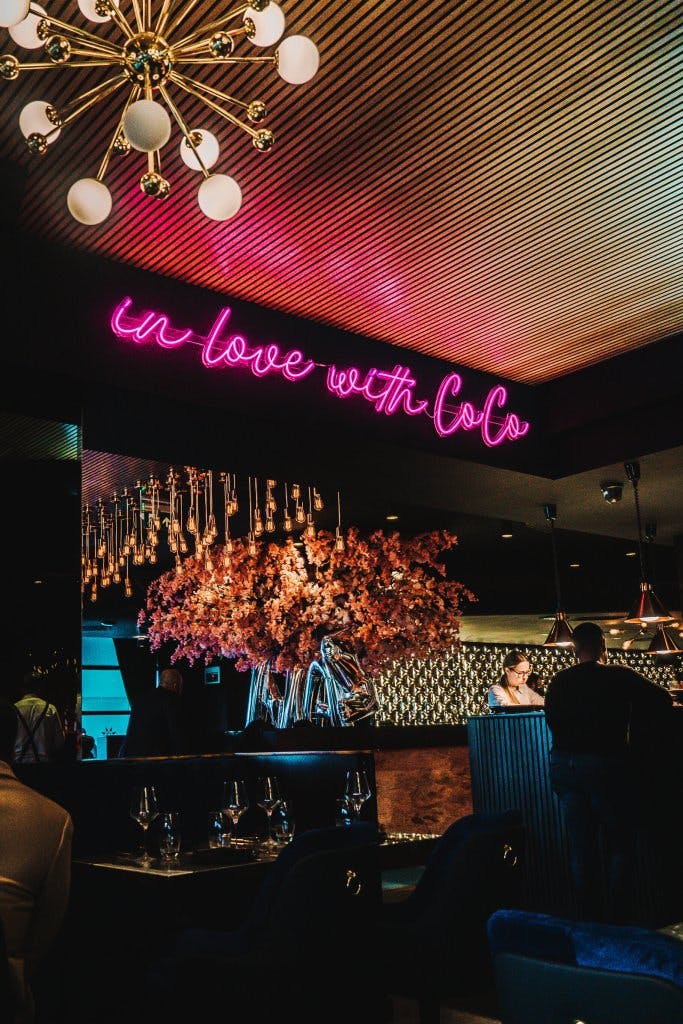 Elegant bar at COCO Restaurants with floral decor, perfect for networking events.