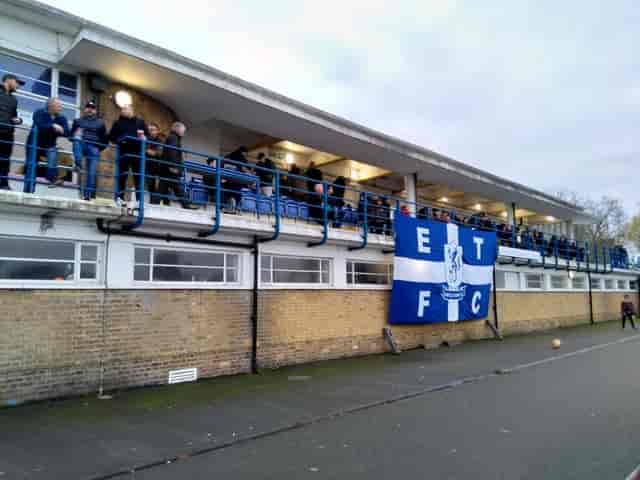 Queen Elizabeth II Stadium with vibrant crowd, ideal for sports events and community gatherings.
