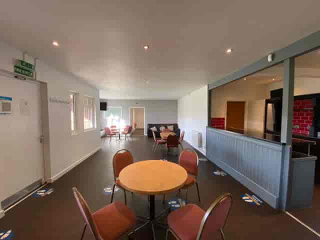 Versatile event space with round table, ideal for meetings and workshops at The Pavilion.