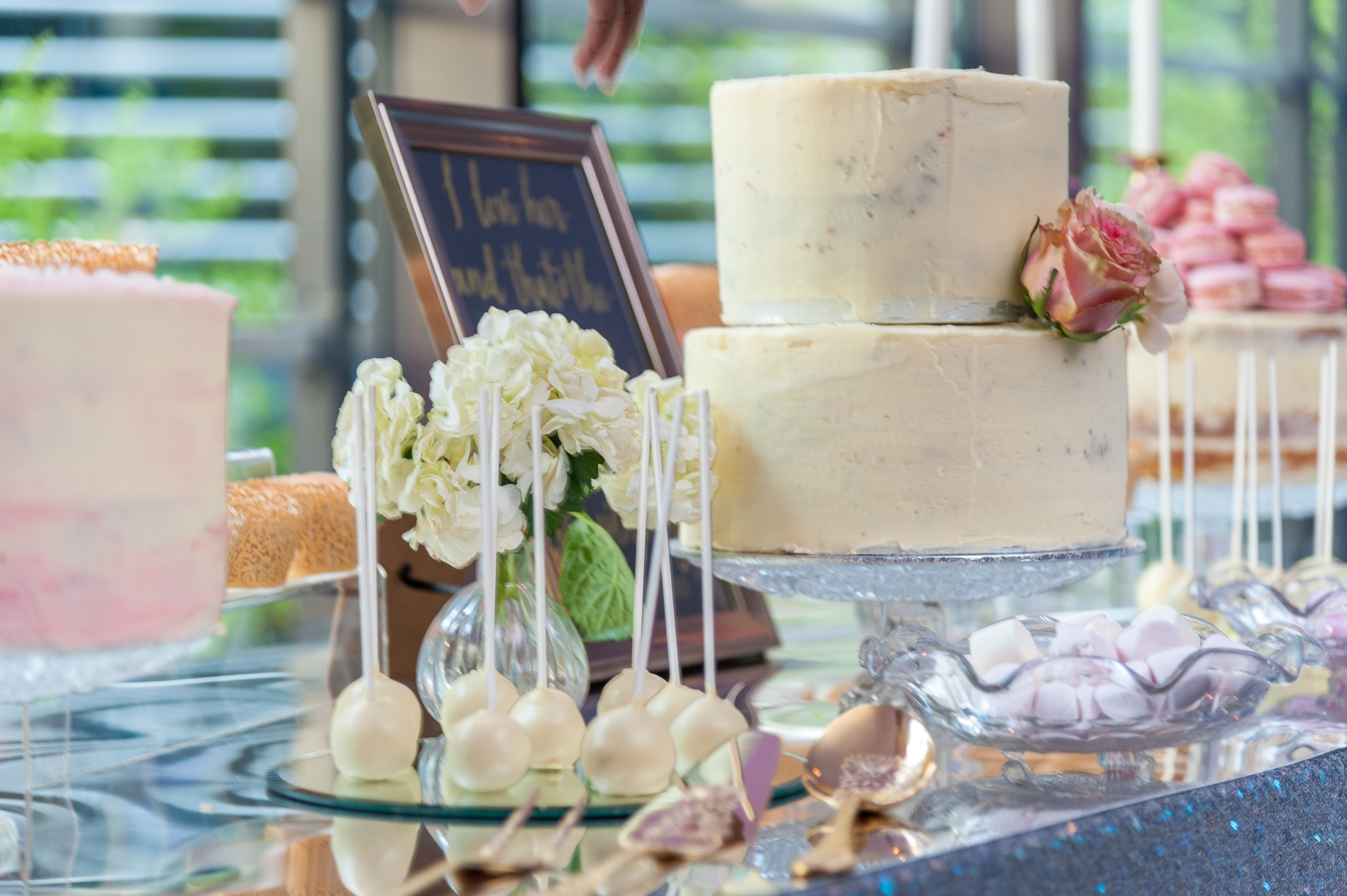 Elegant dessert table with two-tiered cake at Hilton London Tower Bridge for weddings. - Banner