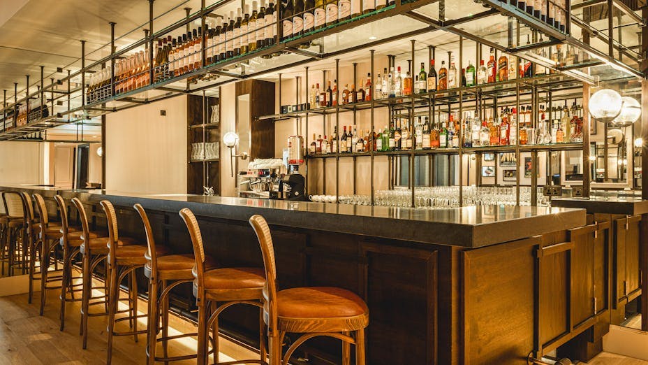 Modern dining room bar setup with polished countertop for networking events.