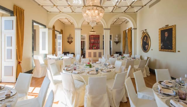 Elegant dining room with white linens, perfect for upscale events and corporate dinners.