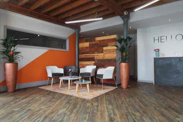 Modern reception area at Beck Mill, featuring orange accents for events and meetings.